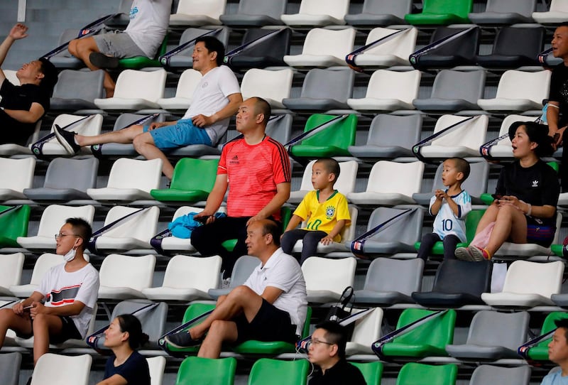 Fans watch the Chinese Super League match between Shanghai SIPG and Beijing Guoan in Suzhou, in China's eastern Jiangsu province. AFP