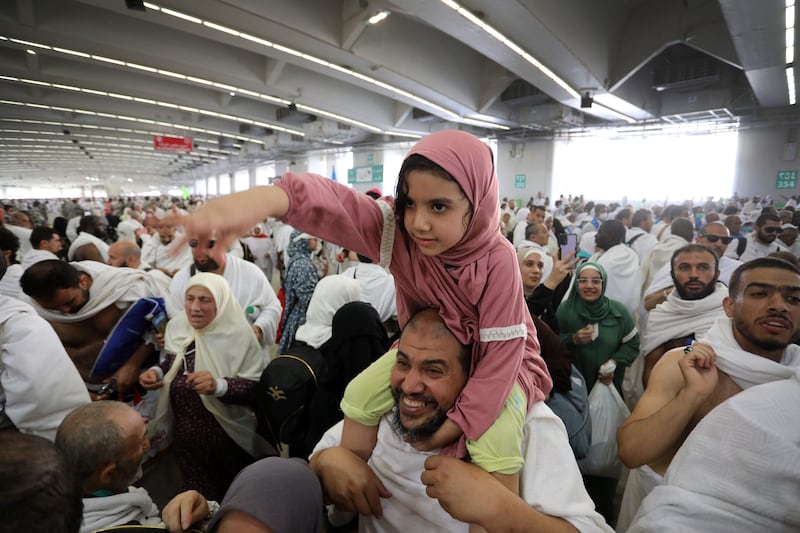 A ride on dad's shoulders during the ceremony at the Jamarat Bridge. EPA
