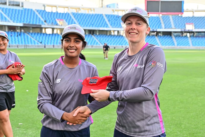 UAE batter Kavisha Kumari receives her cap from her new Barmy Army captain, Heather Knight. 