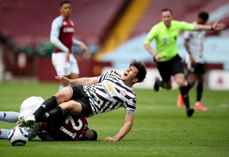United's Harry Maguire goes down injured after clashing with Anwar El Ghazi of Villa. AP