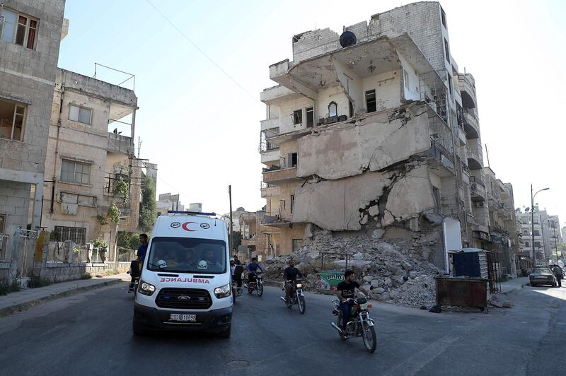 Members of the Syrian Civil Defence known as "White Helmets"  march during the funeral of citizen journalist Anas al-Dyab in the rebel-held city of Idlib in northwestern Syria.  AFP