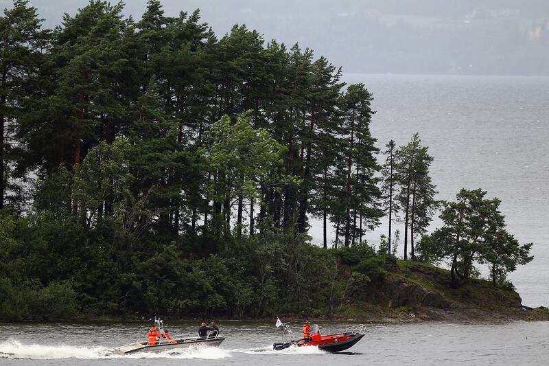 Rescuers search the waters of Utoya island in July 2011.