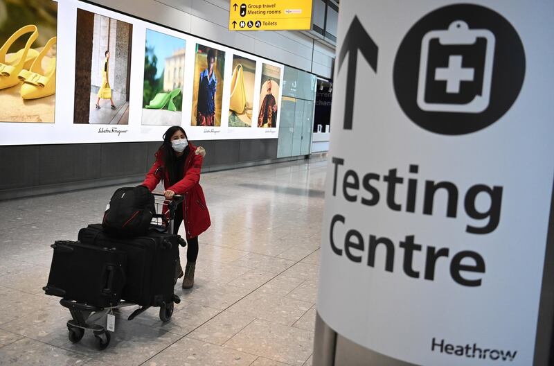 epa08945805 A Traveller in the international arrival area of Heathrow Airport, near London, Britain, 18 January 2021. Travel corridors in the the UK were closed at 04:00 hours on 18 January 2021 as British government declared. Travellers arriving to England from anywhere outside the UK have to to self-isolate for 10 days and must have proof of a negative coronavirus test. Britain's national health service (NHS) is coming under sever pressure as Covid-19 hospital admissions continue to rise across the UK.  EPA/NEIL HALL