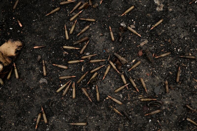 Ammunition scattered on the ground next to a Ukrainian armoured car destroyed in fighting outside Kyiv. AP Photo