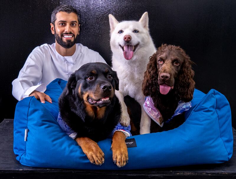 Posh Pets owner Mansoor Al Hammadi poses with his dogs Leila, Luna, and Gucci.