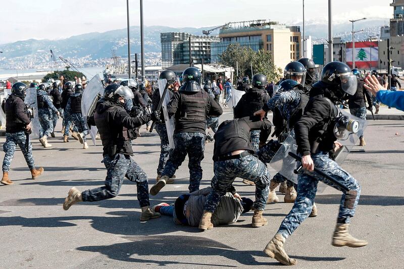 Lebanese riot police beat a fallen anti-government protester during clashes in a demonstration in the centre of the Lebanese capital Beirut.   AFP