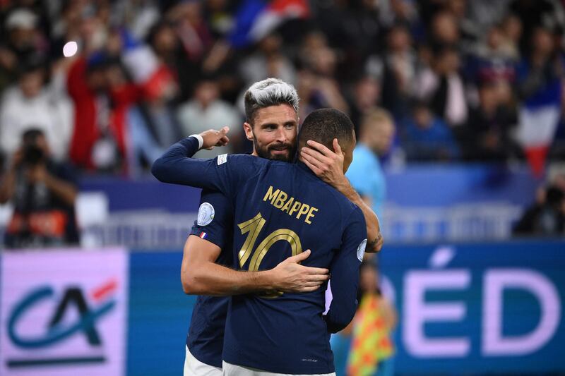 France forward Olivier Giroud embraces teammate Kylian Mbappe after scoring. AFP