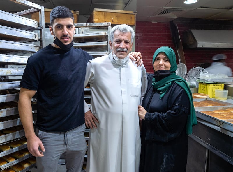 Abu Dhabi, United Arab Emirates, January 10, 2021.  
Saeed Yousef Mardi, center, of Al Yousuf Sweets and Bakeries with his son Saif and wife Arwa.
Victor Besa/The National
Section:  NA
Reporter:  Shireena Al Nowais