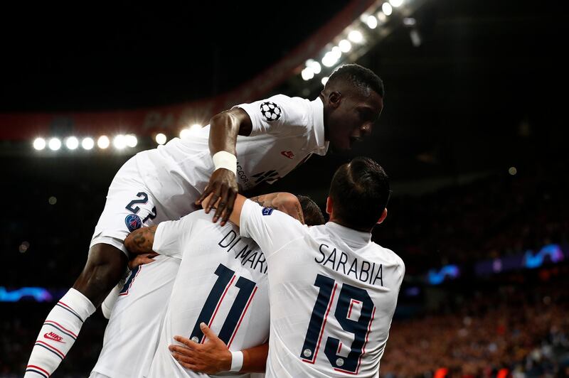 Angel Di Maria of Paris Saint-Germain celebrates with Abdou Diallo and Pablo Sarabia after scoring the first goal in a 3-0 win over Real Madrid at the Parc des Princes. EPA