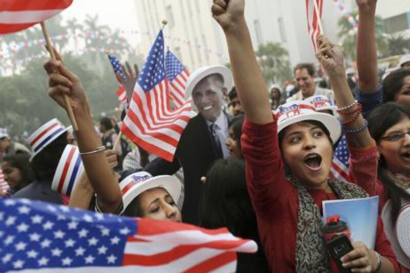 Indian students react in front of photographers next to a cardboard cutout of President Barack Obama after he was projected as the winner of the U.S. presidential election during an event organized by the U.S. Embassy at the landmark Imperial Hotel in New Delhi, India, Wednesday, Nov. 7, 2012. Obama captured a second White House term, blunting a mighty challenge by Republican Mitt Romney as Americans voted for a leader they knew over a wealthy businessman they did not. (AP Photo/Kevin Frayer) *** Local Caption ***  India US Election.JPEG-0d526.jpg