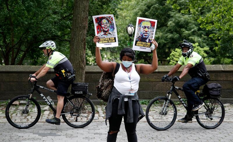 A protester holds up two signs one for Breonna Taylor (L) and the other for George Floyd while demonstrating in New York City.  EPA