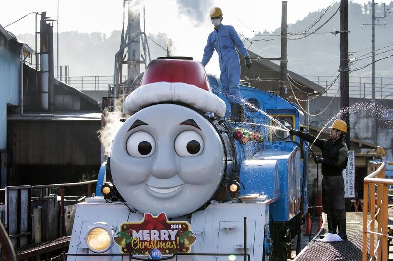 Employees wash Thomas the Tank Engine before departing from Shinkanaya Station during the Day out with Thomas 2018 Christmas event in Shimada, Shizuoka, Japan. Getty