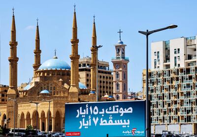 A billboard for the upcoming parliamentary election with text in Arabic reading "your vote on May 15 will nullify May 7", referring to a 2009 incident, in front of the Mohammed Al Amin Mosque and the Maronite Cathedral of St George, at Martyrs' Square, in Beirut. AFP