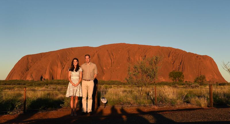 AYERS ROCK, AUSTRALIA - APRIL 22:  Catherine, Duchess of Cambridge and Prince William, Duke of Cambridge pose in front of Uluru, also known as Ayers Rock, on April 22, 2014 in Ayers Rock, Australia. The Duke and Duchess of Cambridge are on a three-week tour of Australia and New Zealand, the first official trip overseas with their son, Prince George of Cambridge. (Photo by William West -  Pool / Getty Images)