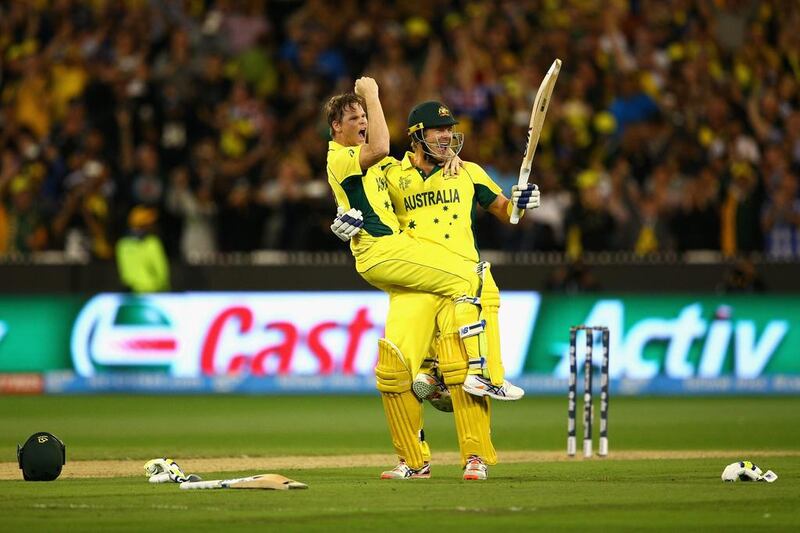 Steve Smith and Shane Watson celebrate after hitting the winning runs to secure the World Cup. Cameron Spencer / Getty Images