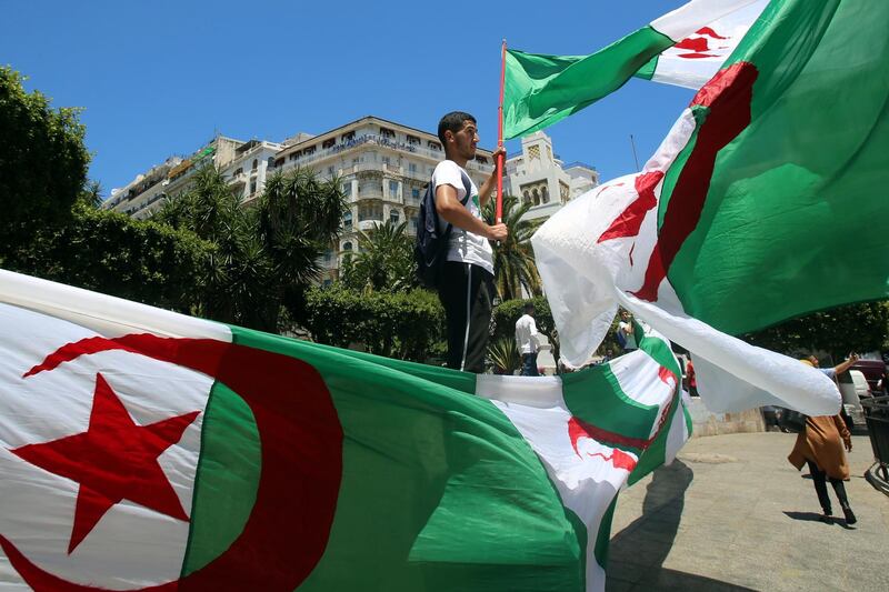 A student waves a national flag during a protest demanding the removal of the ruling elite in Algiers, Algeria. Reuters