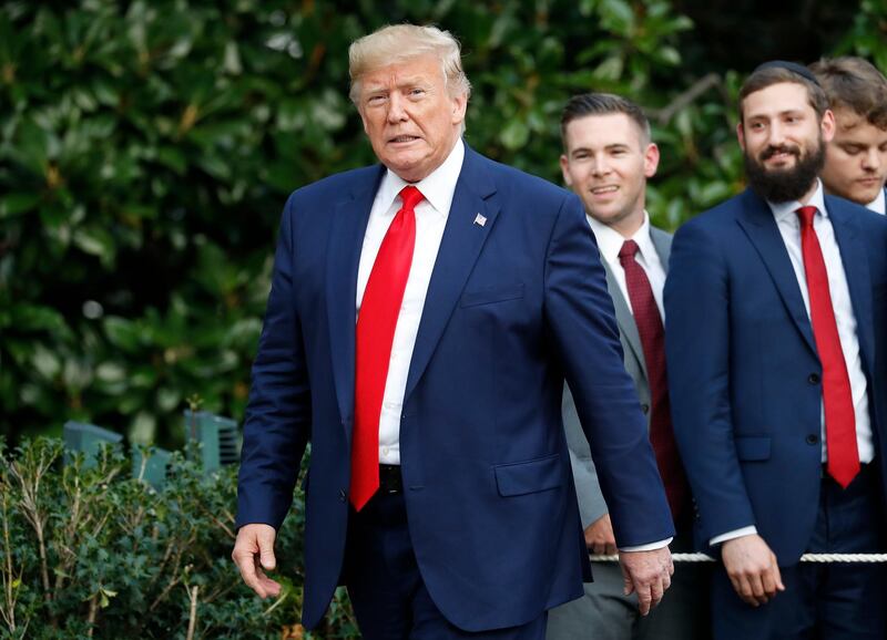 President Donald Trump walks back to the White House in Washington after greeting guests on the South Lawn, Thursday, Oct. 3, 2019. (AP Photo/Pablo Martinez Monsivais)