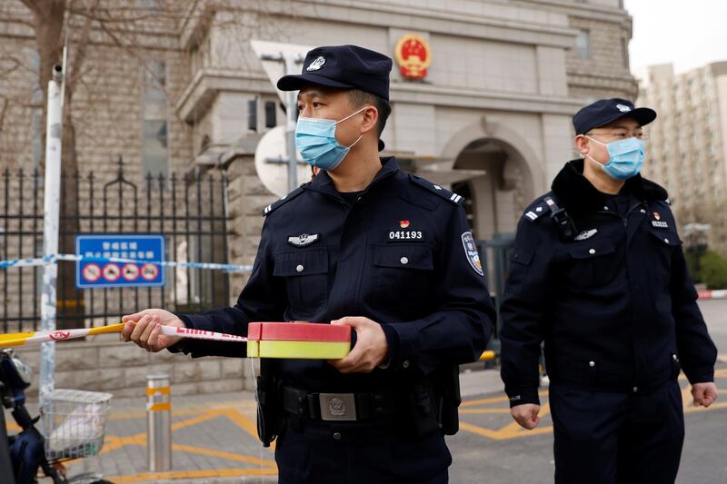 Police officers set up a perimeter outside Beijing No. 2 Intermediate People's Court where Michael Kovrig, a Canadian detained by China in December 2018 on suspicion of espionage, is expected to stand trial, in Beijing, China March 22, 2021. REUTERS/Carlos Garcia Rawlins
