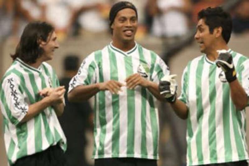 The Brazilian Ronaldinho is flanked by Lionel Messi (left, Argentina), and Jorge Campos (Mexico) before the starts of the Free Kick Masters competition in Houston.