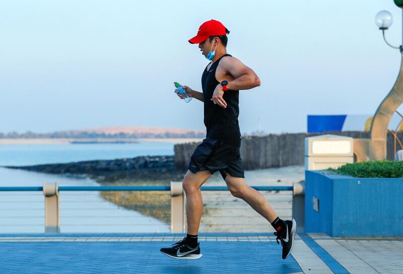 Abu Dhabi, United Arab Emirates, September 21, 2020.  A runner on a hazy morning along the Corniche, Abu Dhabi.
Victor Besa/The National
Section:  Standalone/Weather