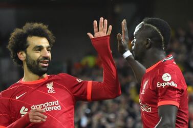 Liverpool's Sadio Mane (R) celebrates with teammate Mohamed Salah (C) after scoring the 2-0 lead during the UEFA Champions League group B soccer match between Liverpool FC and Atletico Madrid in Liverpool, Britain, 03 November 2021.   EPA / Peter Powell