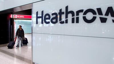 A passenger arrives at Heathrow airport in London. The airport is to reopen Terminal 3 on July 15.  Andrew Cowie / EPA