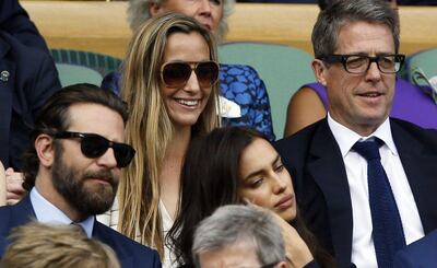 Hugh Grant and Anna Eberstein sit in the Royal Box in Wimbledon in 2016. AP