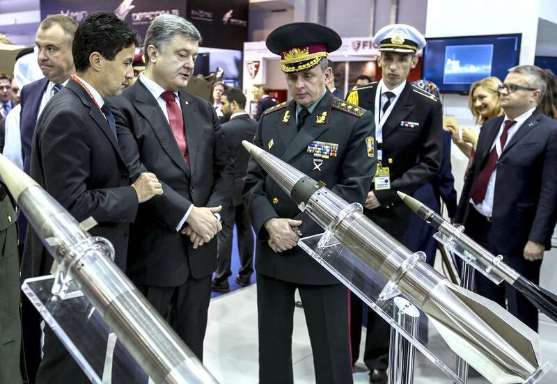 Ukrainian president Petro Poroshenko, third left, and the head of Ukrainian General Staff Viktor Muzhenko, right of Poroshenko, visit the International Defence Exhibition and Conference. Mikhail Palinchak / AP Photo