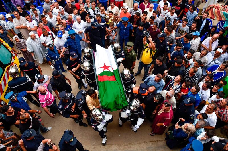 Members of the Algerian civil defence carry the body of Algerian pop-rai star and singer Rachid Taha during his funeral in the town of Sig in Agleria's northwestern Oran province. AFP