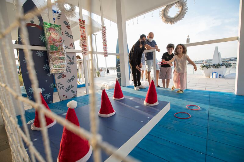 Children play fairground-style games.