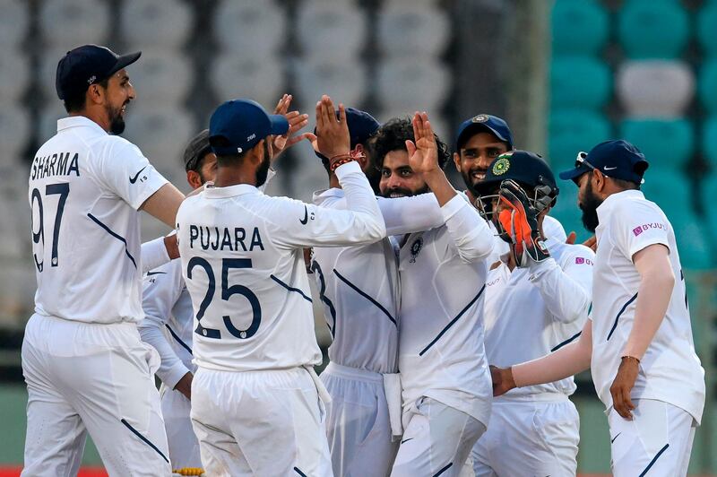 India's Ravindra Jadeja (C) celebrates with teammates after the dismissal of South Africa's Dean Elgar during the fourth day's play of the first Test match between India and South Africa at the Dr. Y.S. Rajasekhara Reddy ACA-VDCA Cricket Stadium in Visakhapatnam on October 5, 2019. ----IMAGE RESTRICTED TO EDITORIAL USE - STRICTLY NO COMMERCIAL USE-----
 / AFP / NOAH SEELAM / ----IMAGE RESTRICTED TO EDITORIAL USE - STRICTLY NO COMMERCIAL USE-----
