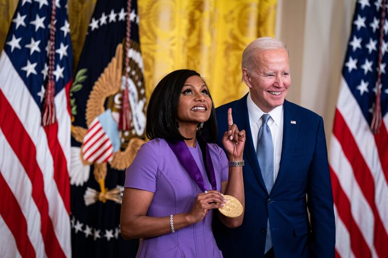 Actress Mindy Kaling receives the 2021 National Medal of Arts from US President Joe Biden during a ceremony in the East Room of the White House in Washington, DC, US, on Tuesday, March 21, 2023.  President Biden is bestowing 12 honorees with the 2021 National Medal of Arts and another 11 with the 2021 National Humanities Medal. Photographer: Al Drago / Bloomberg 