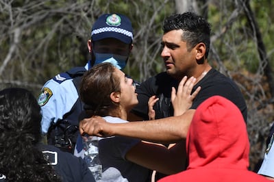 Anthony Elfalak and his wife, Kelly, embrace after hearing their son AJ was found alive. AAP Image via AP