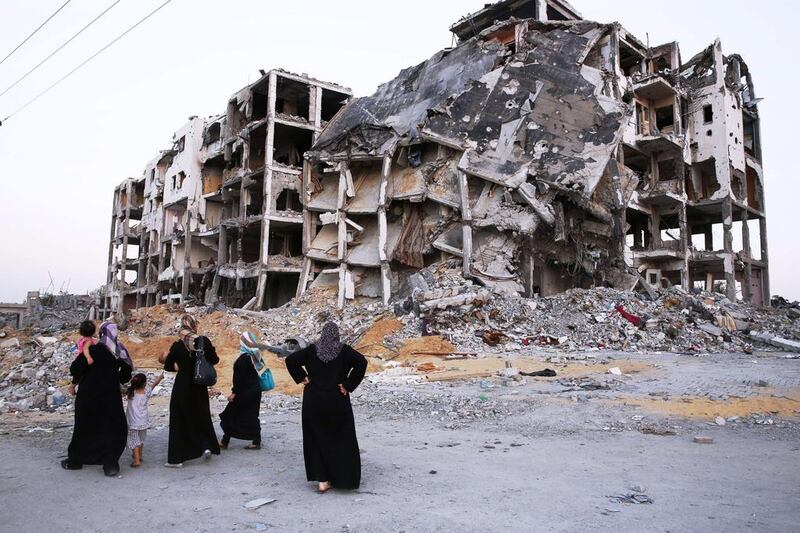 Palestinian women look at the shattered remains of a building complex that was destroyed by Israel this month. The best form of resistance to such brutality is non-violent, argues Hussein Ibish. (AFP PHOTO/ROBERTO SCHMIDT)

