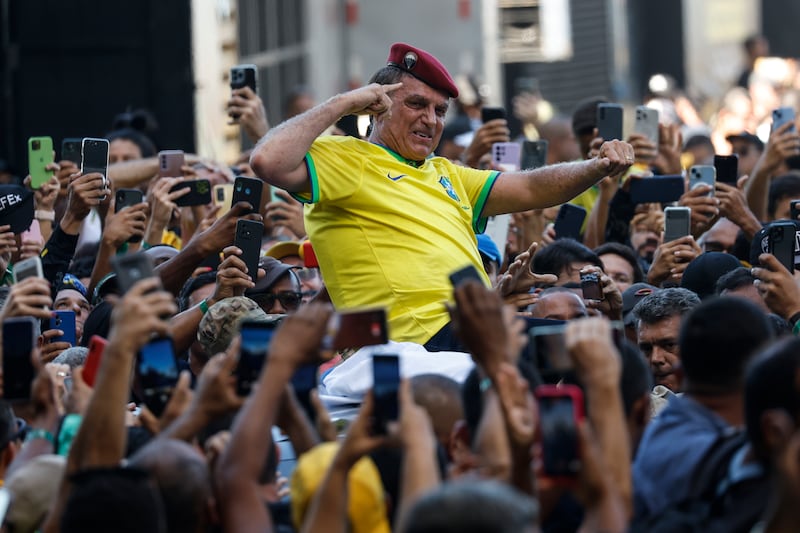 Supporters carry former Brazilian president Jair Bolsonaro at a march in Rio. He had called for the procession to 'defend democracy and freedom of speech'. EPA