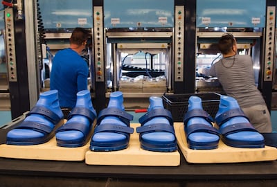 (FILES) This file photo taken on May 10, 2016 shows employees of the Alsa GmbH company in Goerlitz, eastern Germany, working on the production of Birkenstock shoes. A subsidiary of French luxury group LVMH and its billionaire owner Bernard Arnault have purchased a majority stake in Birkenstock, the German maker of the iconic and eponymous sandals said on February 26, 2021. - Germany OUT
 / AFP / dpa / Arno Burgi
