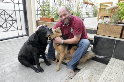DUBAI, UNITED ARAB EMIRATES , Feb 10 – Jason with his dogs Bella (brown) and Charlie (Black) at his home in Jumeirah 1 in Dubai. (Pawan Singh / The National) For News/Online/Instagram. Story by Kelly