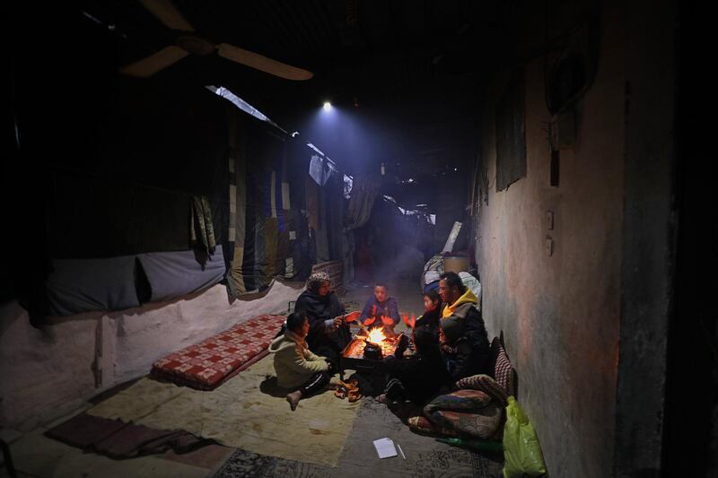 epa06455112 A Palestinian refugee family warm themselves by a fire in their house during cold weather in Khan Younis refugee camp in the southern Gaza Strip, 19 January 2018. Media report that the US President Donald J. Trump had vowed to freeze about 125 million US dollar of aid for the United Nation Relief and Works Agency (UNRWA) for Palestine Refugees. The US ambassador to the Unaited Nation (UN) Nikki Haley was quoted as saying that Trump did not want to add or stop funding until the Palestinians were agreeing to return to the negotiation table. Following the 1948 Arab-Israel conflict, UNRWA was established by the United Nation General Assembly Resolution 302 (IV) in 1949 to carry out direct relief and works programs for Palestine refugees from May 1950 on until today. Some five million Palestine refugees are eligible for their services, UNRWA says on their website.  EPA/MOHAMMED SABER
