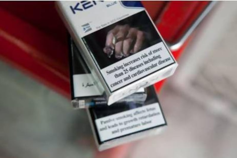 Grisly images on cigarette packs warning of the dangers of smoking will do little to put smokers off the habit, a new survey suggests. Silvia Razgova / The National