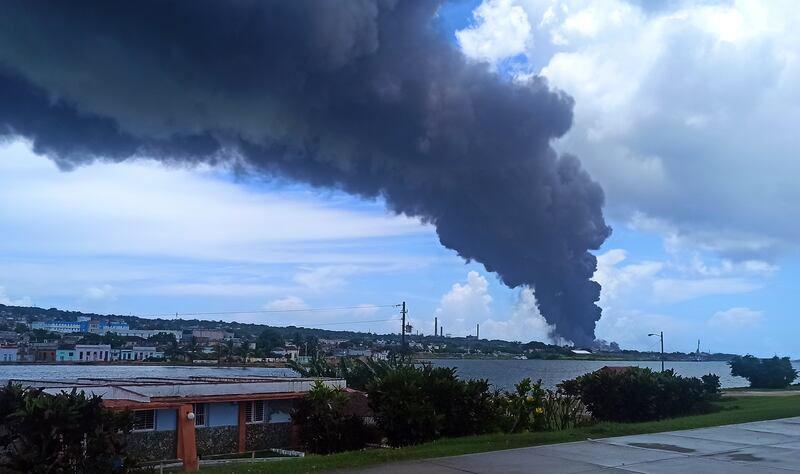 A column of smoke rises from a fire at a fuel depot in Matanzas, Cuba. According to the authorities, 17 firefighters have gone missing while tackling the blaze. EPA 