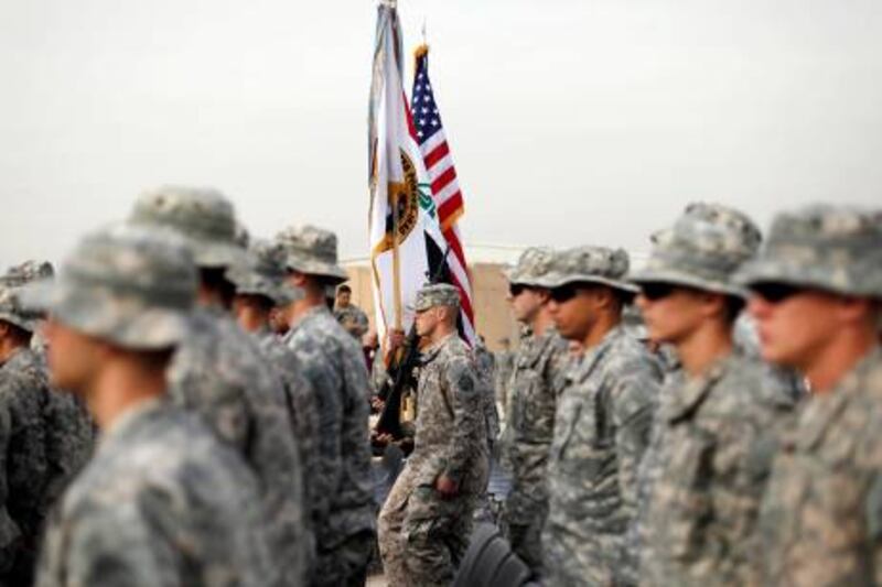 U.S. soldiers carry an U.S. national flag, an Iraq national flag, and the U.S. Forces in Iraq colors during ceremonies marking the end of the U.S. military mission, in Baghdad December 15, 2011. The U.S military officially ended its war in Iraq on Thursday, packing up a military flag at a ceremony with U.S. Defense Secretary Leon Panetta nearly nine years after the invasion that ousted Saddam Hussein.     REUTERS/Pablo Martinez Monsivais/Pool (IRAQ - Tags: POLITICS MILITARY CONFLICT) *** Local Caption ***  SIN61_IRAQ-WITHDRAW_1215_11.JPG