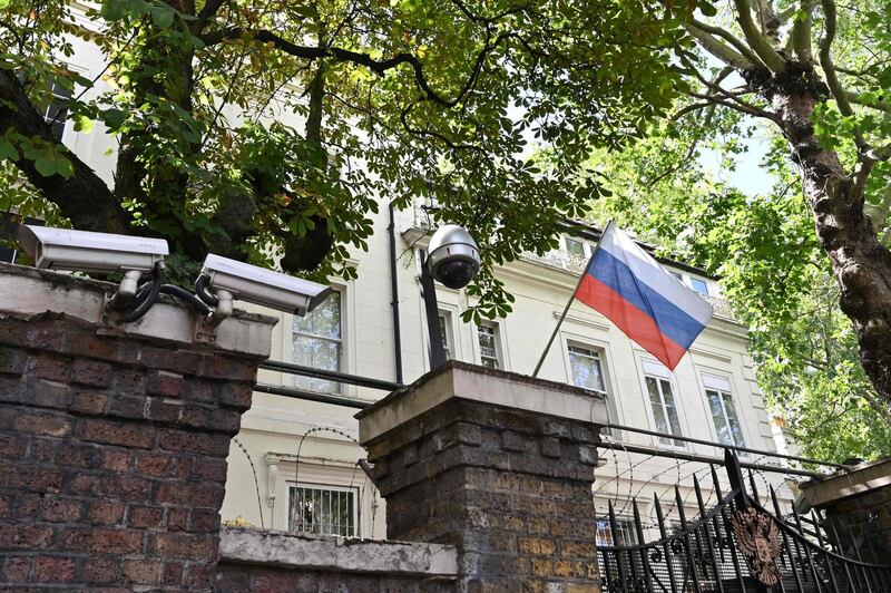 (FILES) In this file photo taken on July 21, 2020 A Russian flag flies by surveillance cameras at the entrance to the Russian consulate in London.  Russia's ambassador to Britain said on March 21, 2021 that diplomatic ties between the two countries were "nearly dead", after a UK strategic review this week branded Moscow an "acute direct threat". Andrei Kelin also criticised Britain's decision to bolster its nuclear stockpile, arguing the reversal of decades of policy was a violation of various international agreements.
 / AFP / JUSTIN TALLIS

