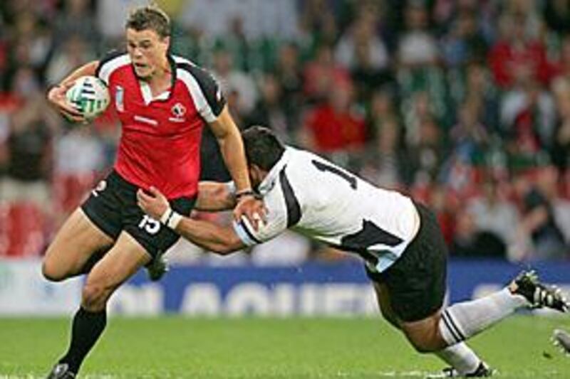 Canada's Mike Pyke, left, runs with the ball during the Rugby World Cup match between Fiji and Canada back in 2007. Pyke is set for his AFL debut.