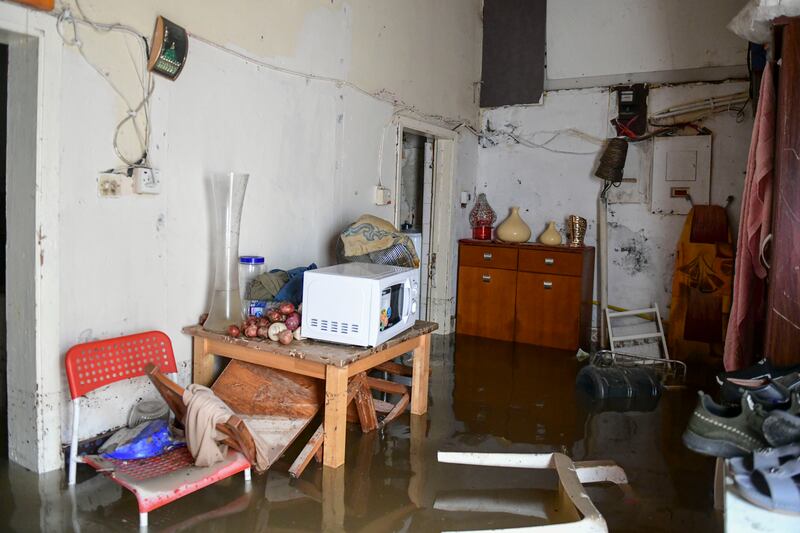 Property belonging to Wali Said, from Pakistan, inside his flooded home in Kalba. Khushnum Bhandari / The National