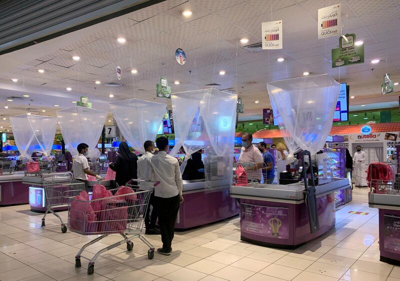 People shop at a supermarket after the Saudi government eased a curfew in Riyadh. Reuters