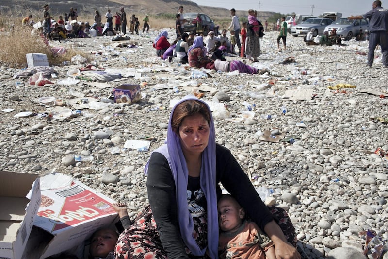 FISHKHABOUR, IRAQ: A Yezidi woman breaks down in tears after crossing from Syria back into Iraq. Tens of thousands of Yezidi--an minority ethno-religious group in Iraq--have made there way to safety after being stranded on Mt. Sinjar. They escaped to the mountain after coming under attack by ISIL (The Islamic State of Iraq and the Levant). After days of being stranded, they were able to safely descend the mountain into Syria and then cross back into Iraq further north. (Photo by Sebastian Meyer/Corbis via Getty Images)