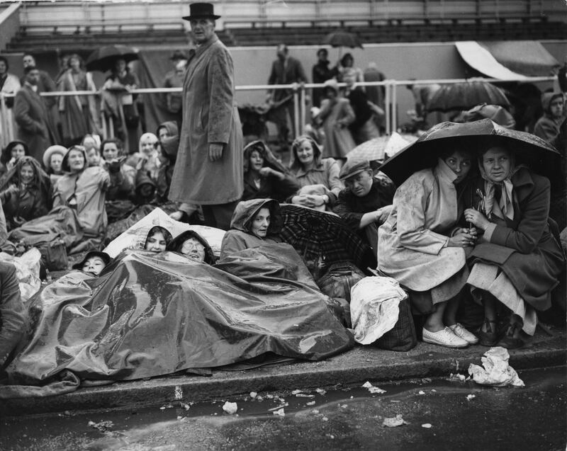 People waiting on The Mall for an all-night vigil before the coronation procession of Queen Elizabeth.