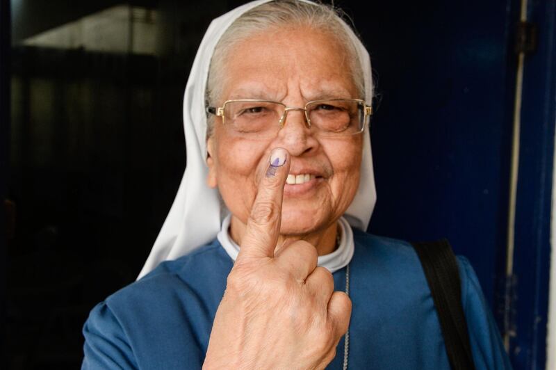 An Indian Catholic nuns shows her finger after voting in Hyderabad. AFP