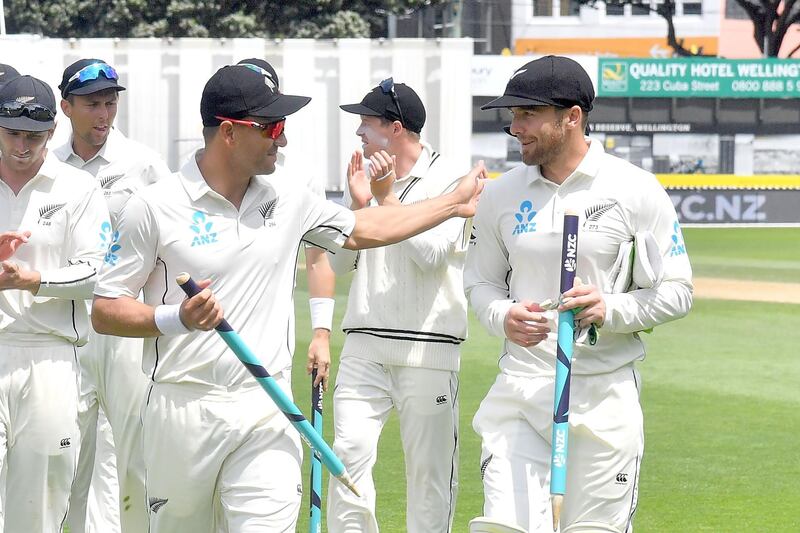 New Zealand's Neil Wagner (L) with teammate Tom Blundell walk from the field after New Zealand's win during day four of the first Test cricket match between New Zealand and the West Indies at the Basin Reserve in Wellington on December 4, 2017. / AFP PHOTO / Marty MELVILLE