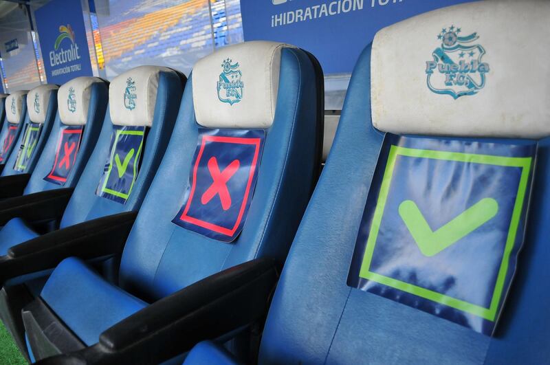 The seats of the benches with social-distancing stickers at the Cuauhtemoc stadium in Puebla, Puebla state, Mexico. AFP